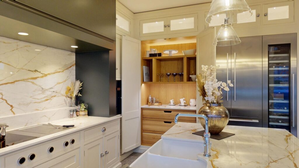 Luxury kitchen with marble-effect worktops, integrated fridge freezer and bespoke storage